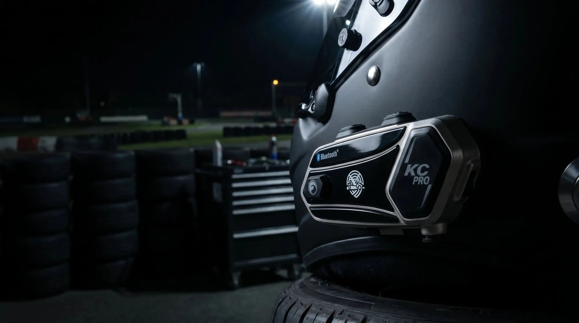 KC-PRO module mounted on a racing helmet under floodlights